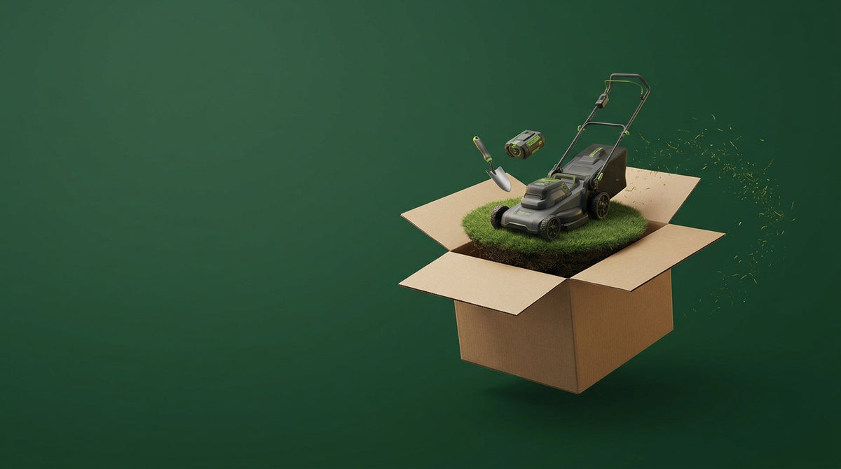 A delivery box opening to reveal a lawn mower on a patch of turf